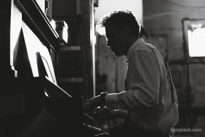 Uomo che suona il pianoforte in un’atmosfera intima e romantica in bianco e nero